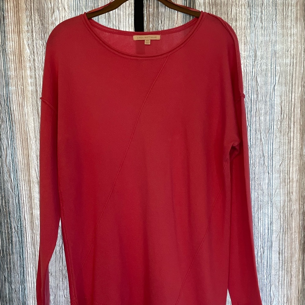 Pink sweater with asymmetrical hem